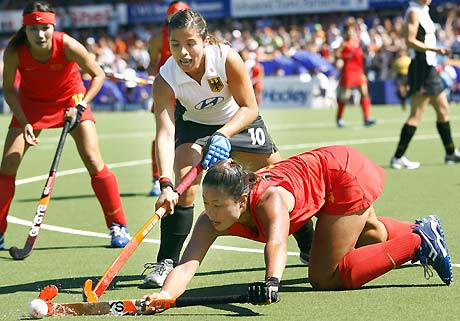 China's Yi Bo Ma (R), and Silke Mueller of Germany fight for the ball during their Champions Trophy Women's Field Hockey Tournament final match in Amstelveen, the Netherlands, July 16 2006.