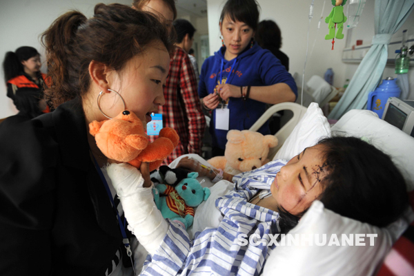 志愿者為在成都接受治療的玉樹地震傷員獻(xiàn)愛心