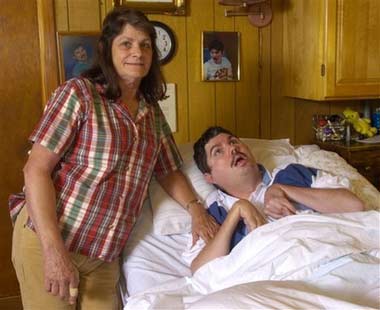 Terry Wallis, right, is shown with his mother Angilee Wallis in his parents home in Stone County, Ark., Saturday July 1, 2006. For the first time, doctors say they have proof the brain can grow its own repairs. Their evidence is Wallis who regained speech and movement after being barely conscious for nearly 20 years. The scientists say Terry Wallis' brain spontaneously rewired itself by replacing the tiny nerve connections that were cut in a car crash. (AP Photo