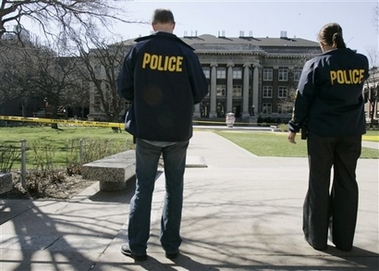 Police officers keep guard in a cordoned off area of the University of Minnesota as eight buildings on campus were evacuated after a bomb threat Wednesday, April 18, 2007 in Minneapolis.